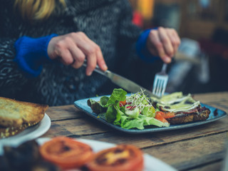 Woman eating salad in a cafe