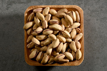 Pistachio nuts in a wooden bowl, still life