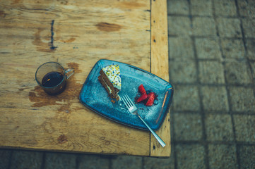 Cake and strawberries on table outdoors