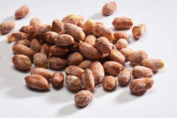 Group of salted peanuts on white background