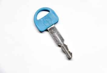 The key to the lock is isolated on a white background. Plastic dummy key from the lock (keychain). The key to the car. Flat key.