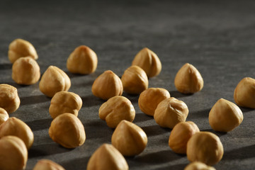 Hazelnuts on the black stone texture