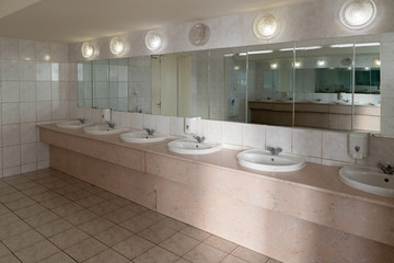 public toilet, with sink in a bright room