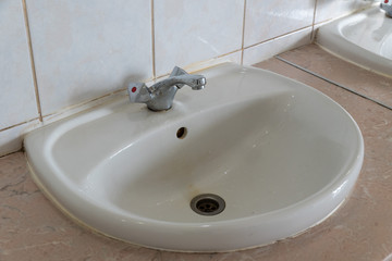 public toilet, with sink in a bright room