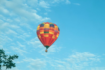 one colorful balloon in the morning sky