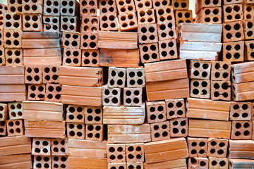 orange bricks, ready for construction, with holes