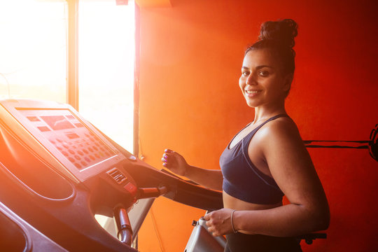 Indian Asian Female Running At Sunny Gym. Latin American Sportwoman Feeling Good Mood At Morning Home