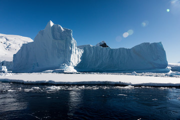 Pinnacle shaped iceberg floating in the cold water of Antarctica © Gabi