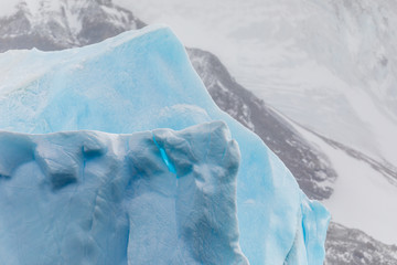 Closeup details of large iceberg floating in the cold water of Antarctica