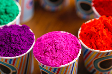 Indian festival Holi concept, colors cup arrange on wooden board 