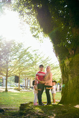 Naklejka premium A landscape view of a muslim family posing happily