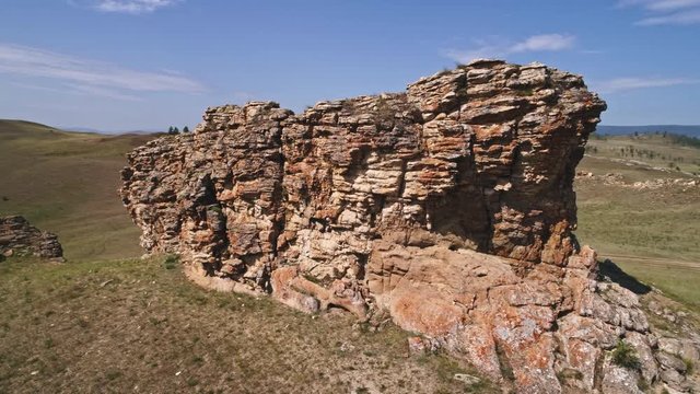 Baikal Valley spirits,Tazheran steppe, stone cliffs on the road. Aerial Summer