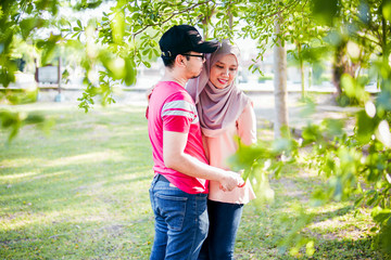 Married Muslim couple sharing beautiful romantic moments with each other at a park