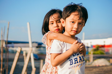 Cute little brother and sister holding hand and having fun