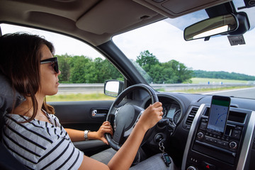 Fototapeta na wymiar woman driving car by speedway summer time