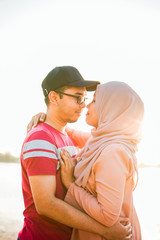 Married Muslim couple sharing beautiful romantic moments with each other at a park