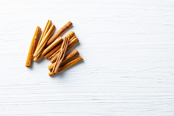 Cinnamon sticks on white text space. Top view.Organic spice concept.