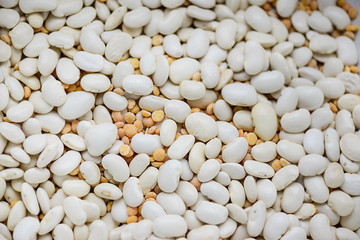 Background of dry white beans and peas. Horizontal orientation, selective focus.