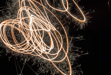 Sparklers in movement - ornamental light zigzags, streaks of light.