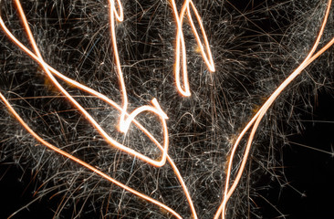 Sparklers in movement - ornamental light zigzags, streaks of light.