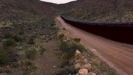 Drone flying along United States and Mexico revealing gap in border fence