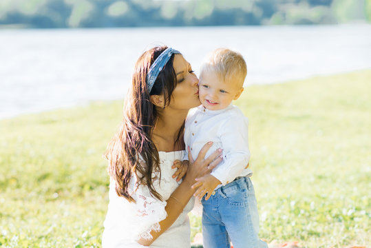Family weekend: mom kisses her two year old son on the cheek