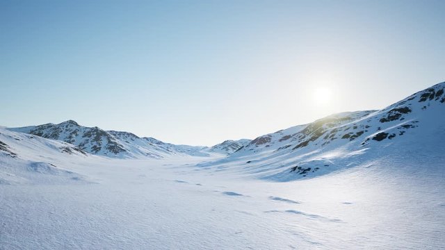 Aerial Landscape of snowy mountains and icy shores in Antarctica