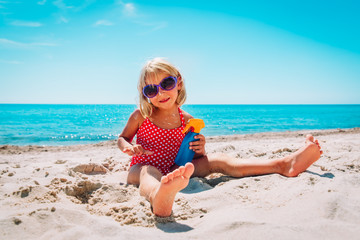 sun protection - cute little girl with suncream at beach