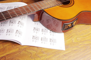 Fototapeta na wymiar Electric guitar and guitar chords table. Learning to play the guitar.
