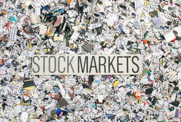Newspaper confetti from above with the word STOCK MARKETS