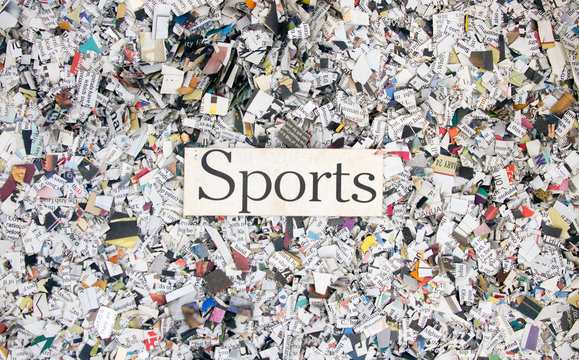 Newspaper confetti from above with the word SPORTS