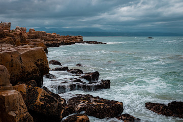Fototapeta na wymiar Sea view with rocks, waves breaking on the rocks.