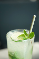 lime soda with fresh lime on clear glass with dark background