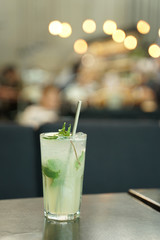 lime soda with fresh lime on clear glass with dark background