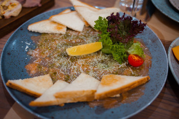 Cold appetizers on a plate in a restaurant.