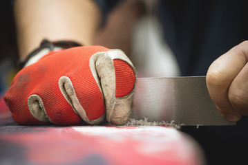 Snowboard repair process close up.