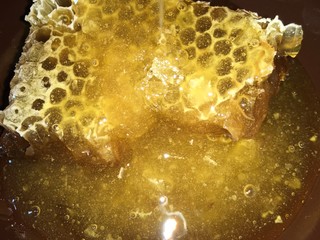 abstract hexagonal background natural fresh golden liquid honey honeycombs