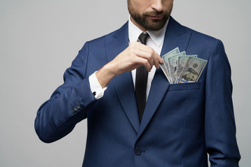 young handsome businessman holding US dollar bills