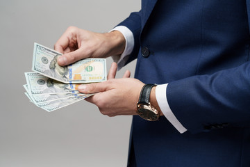 young handsome businessman holding US dollar bills
