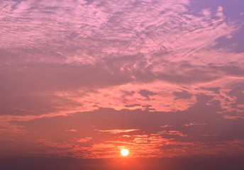 The sky and the light of the sun surrounded by clouds