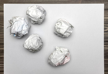 top view of a sheet of white paper and crumble paper balls. inspiration, creativity and Business workplace Concept. space for text