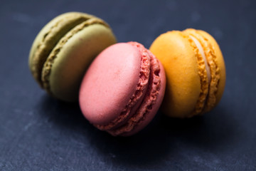 delicious colorful macaroons on ceramic background