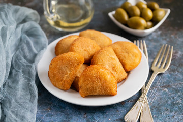 typical portuguese snack with meat rissois de carne on ceramic background