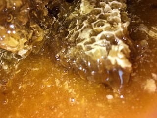 abstract hexagonal background natural fresh golden liquid honey honeycombs