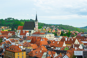 Obraz premium View of the village of Cesky Krumlov and green hill from the Castle, with St. Vitus Church at the background, in Czech Republic