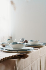Table setting with stylish dishware on beige tablecloth