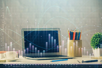 Financial graph colorful drawing and table with computer on background. Multi exposure. Concept of international markets.