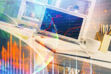 Financial graph colorful drawing and table with computer on background. Multi exposure. Concept of international markets.