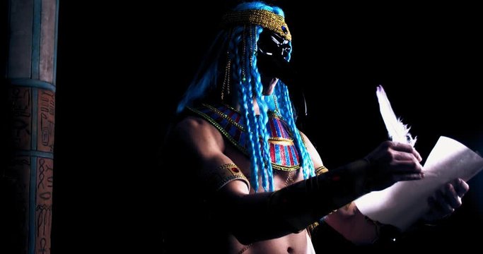 Egyptian god Thoth is writing on a scroll with a feather, looking at the camera