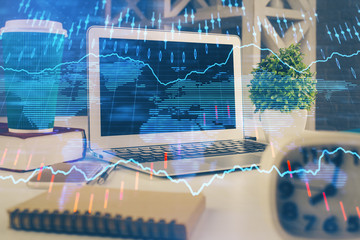 Forex market chart hologram and personal computer background. Double exposure. Concept of investment.